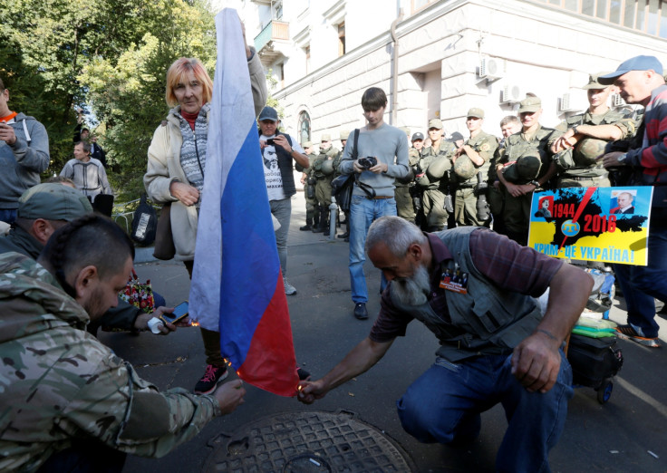 Protesters burn a Russian flag