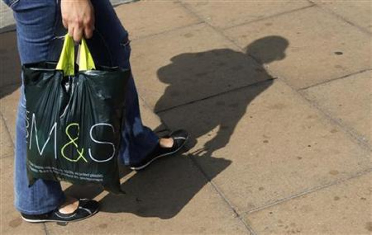 A shoppers carries a Marks and Spencer bag on Oxford Street in London