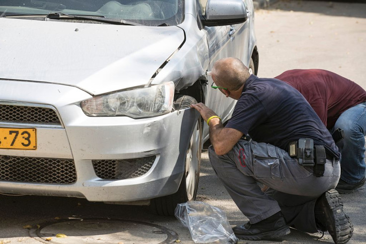 Police ninspect the damage after a rocketattack