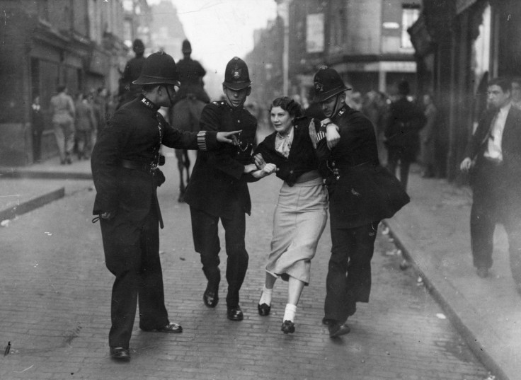 Policemen arresting a demonstrator