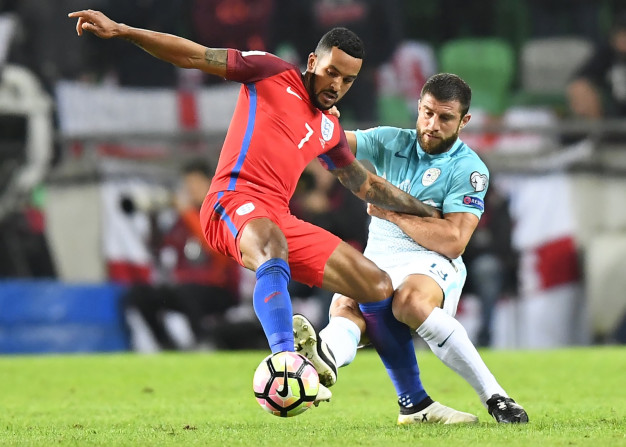 Theo Walcott holds off a defender Theo Walcott holds off a defender