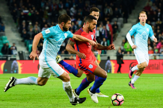 Theo Walcott holds off a defender Theo Walcott holds off a defender