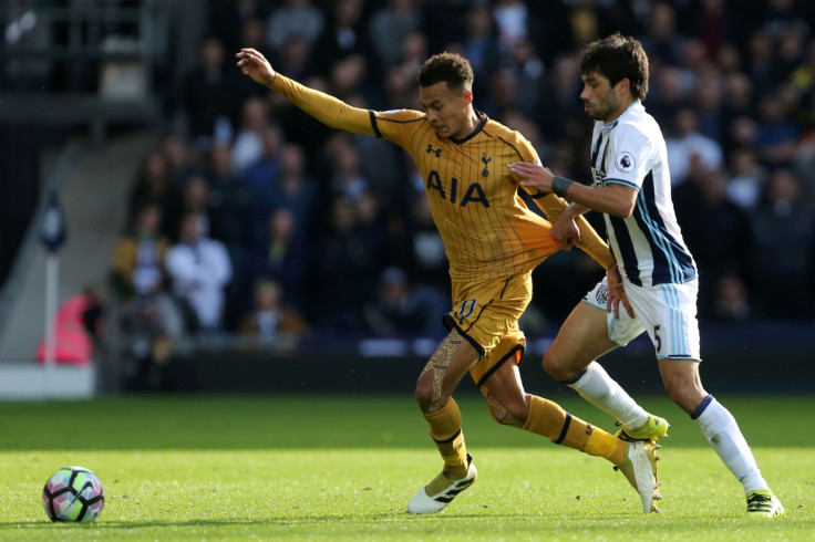 Dele Alli tries to wriggle free