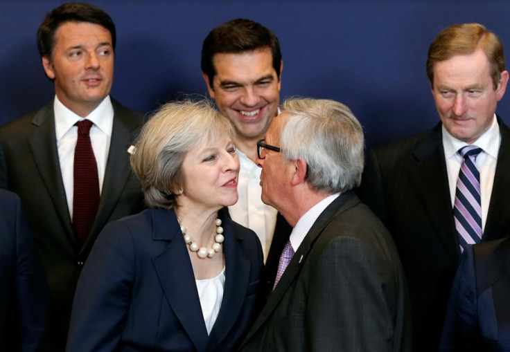 European Commission President Jean-Claude Juncker kisses Britain's Prime Minister Theresa May