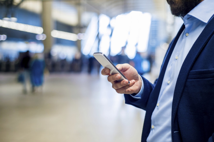 A man using an iPhone in tubestation