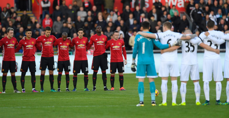 The teams observe a minute's silence