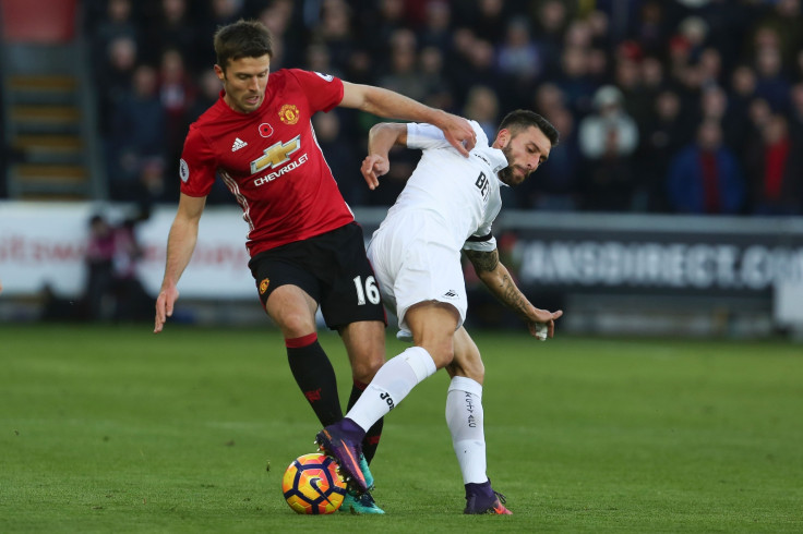 Michael Carrick wins the ball