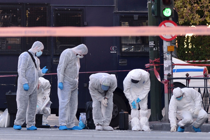 Police officers examine the entrance to the French embassy