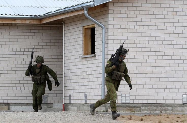 Lithuanian army soldiers take part in an exercise following the official opening of a military training centre for urban warfare in Pabrade, Lithuania, on August 30, 2016. 