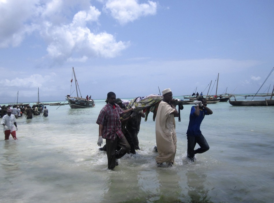 Rescuers carry the bodies of victims from a ferry tragedy near Zanzibar Island at Nungwi Beach