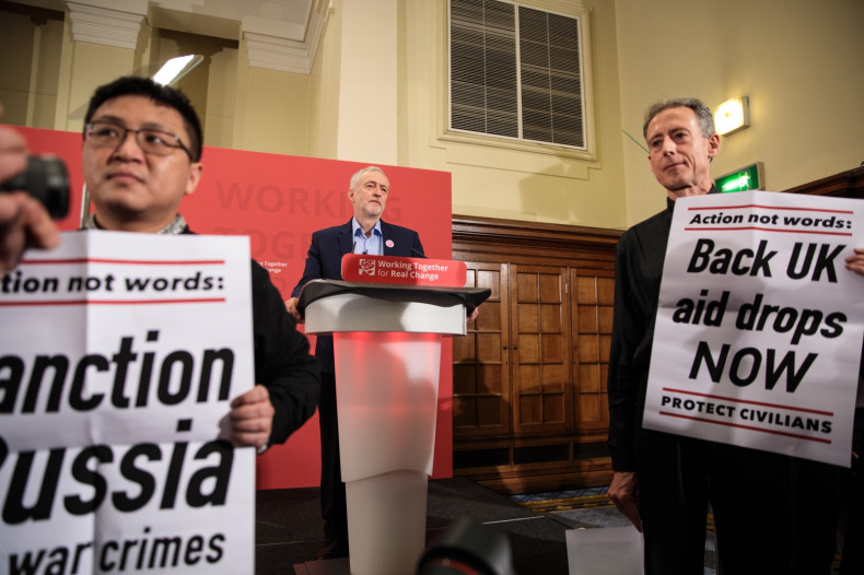 Peter Tatchell (R) stages a protest as Labour Leader Jeremy Corbyn (C) makes speech on International Human Rights Day