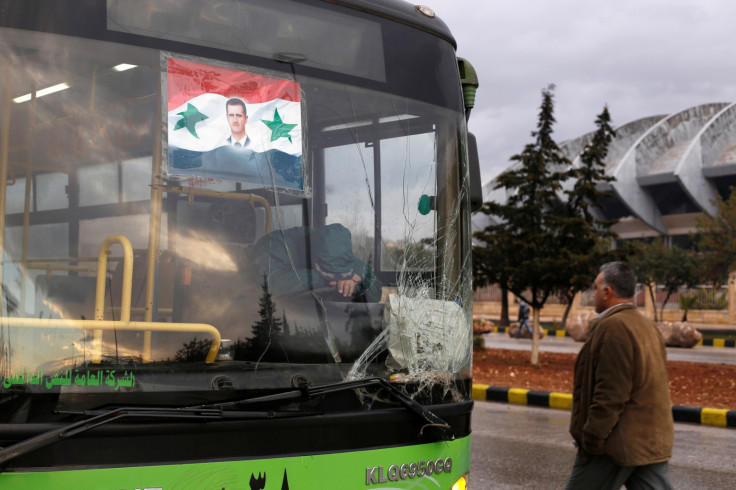 A bus driver waits to evacuate people from a rebel pocket in Aleppo