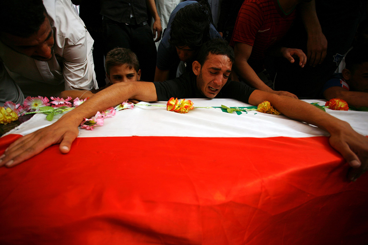 Iraqis mourn over a coffin