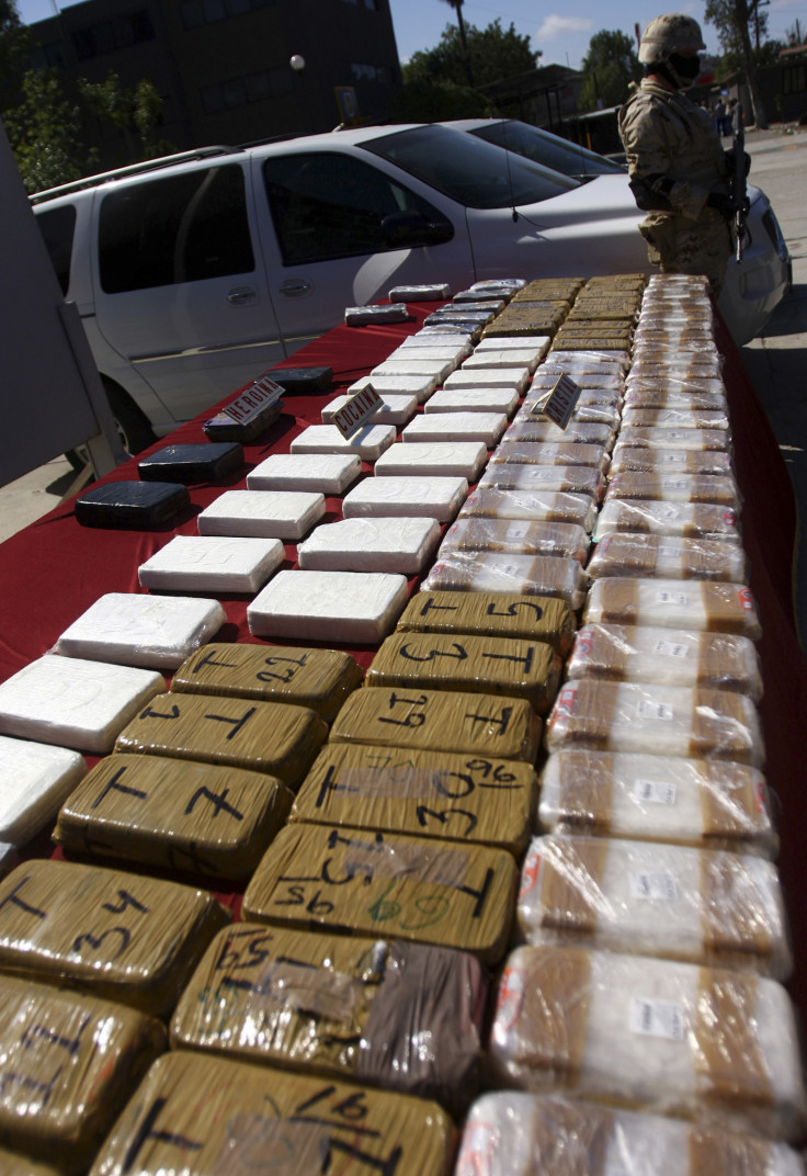 A soldier stands next to packages containing confiscated drugs during a presentation to the media in Tijuana 