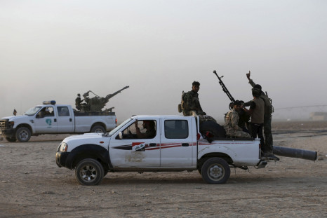 Shi'ite fighters ride vehicles