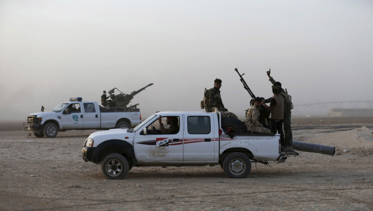 Shi'ite fighters ride vehicles