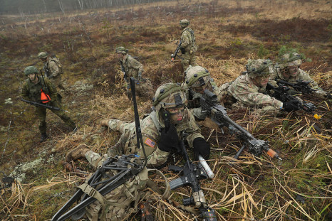 Members of the U.S. 173rd Airborne Brigade and a Lithuanian infantry soldier (L) participate in the Iron Sword multinational military exercises on November 24, 2016