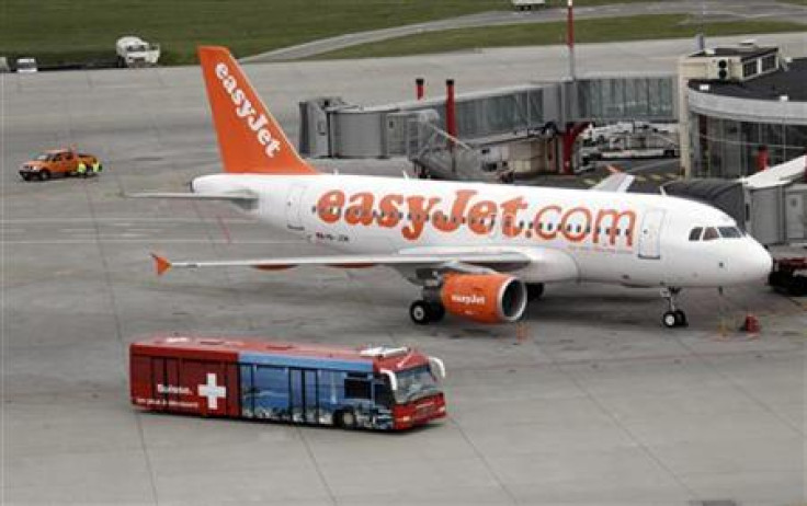 A bus carrying passengers passes an Easyjet aircraft at Cointrin airport in Geneva