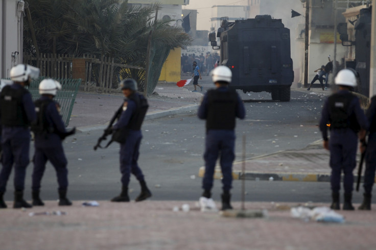 A protester confronts a riot police