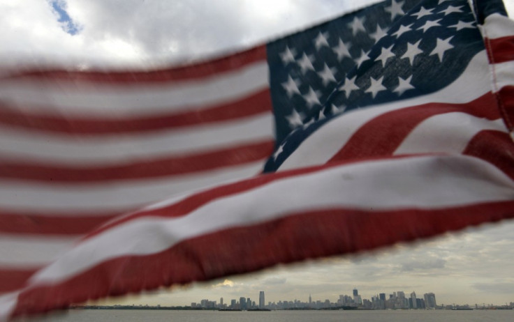 A U.S. flag flutters over top of the skyline of New York and Jersey City as seen from Bayonne, New Jersey