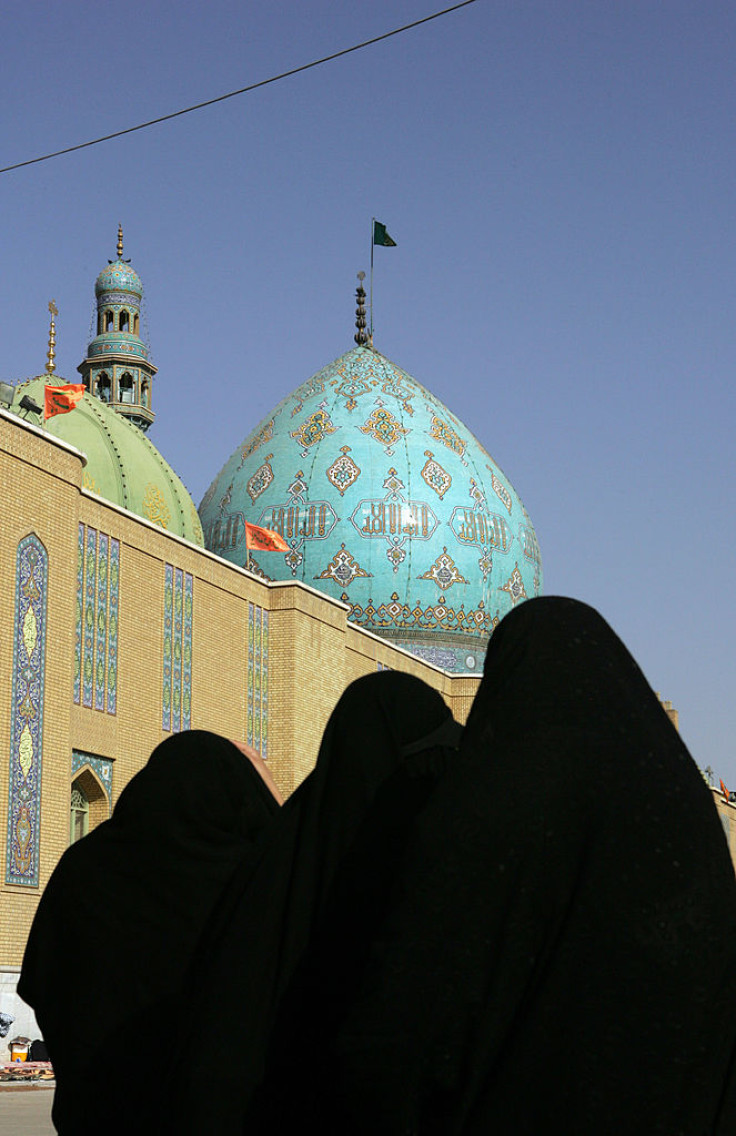 Iranian women walk in the courtyard of the Jamkaran mosque outside the religious city of Qom 