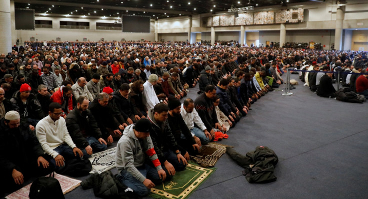 People pray during a funeral ceremony