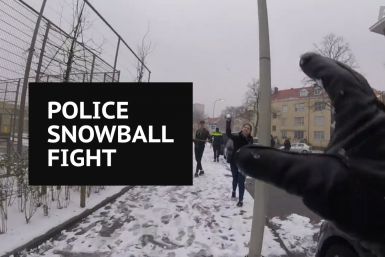 Dutch police officers take on local kids in snowball fight