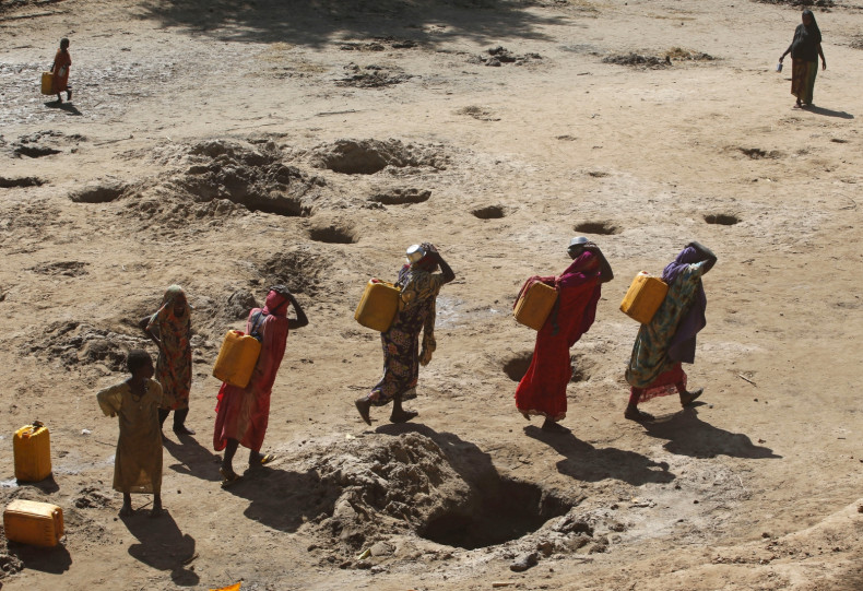 Women carry jerry cans of water