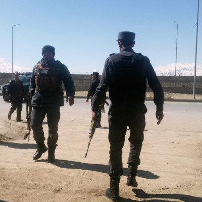 Afghan policemen arrive at the site of a blast