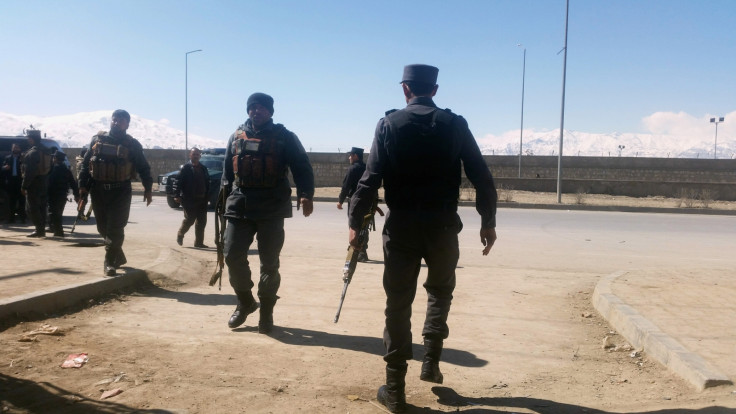 Afghan policemen arrive at the site of a blast