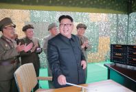 North Korean leader Kim Jong-Un (C) inspecting a test of the surface-to-surface medium long-range strategic ballistic missile 