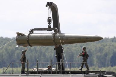 Russian servicemen equip an Iskander tactical missile