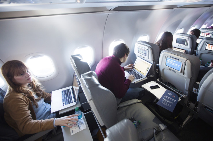 Journalists using laptops on wifi-equipped airplane