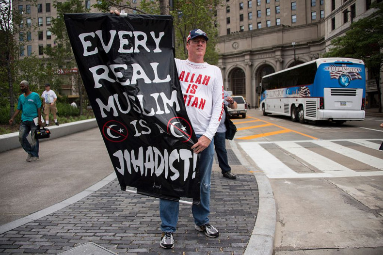 A Donald Trump supporter holds up an anti-Muslim poste