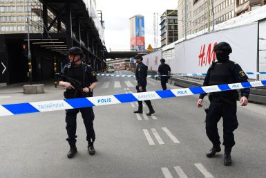 Police officers cordon off the scene where a truck crashed into the Ahlens department store at Drottninggatan in central Stockholm