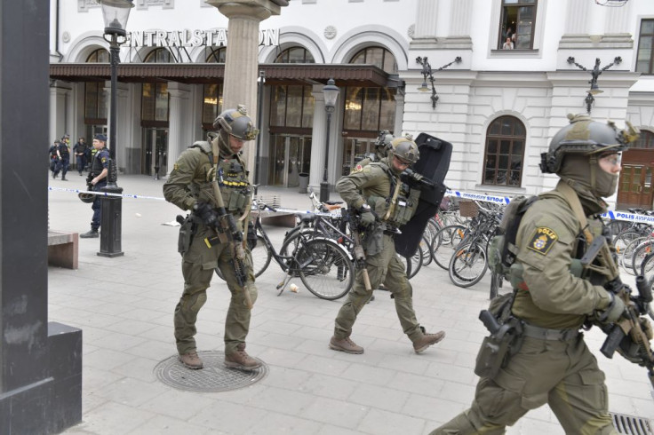 Police officers secure the area outside Stockholm Central station, on April 7, 2017 after a truck crashed into department store Ahlens on Drottninggatan, in central Stockholm
