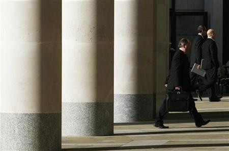City workers walk outside the London Stock Exchange in Paternoster Square