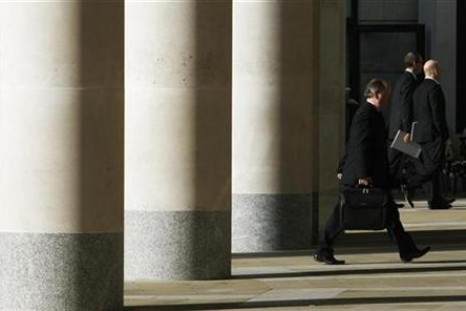 City workers walk outside the London Stock Exchange in Paternoster Square