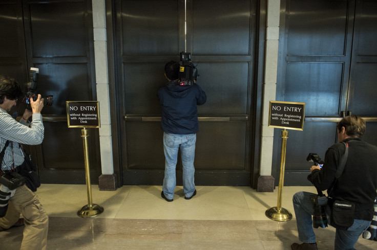 Cameraman tries to see through door crack