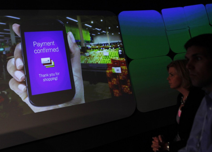 Attendees watch a demonstration of the Google Wallet during a news conference unveiling the mobile payment system in New York. Reuters/Shannon Stapleton