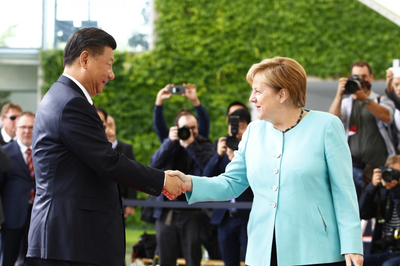 Xi Jinping is greeted by Angela Merkel