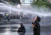 Protester blows bubbles under water cannon Protester blows bubbles under water cannon