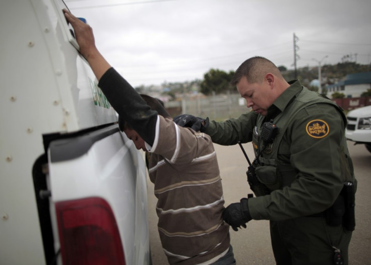A United States border patrol agent catches an illegal immigrant crossing from Mexico to the U.S. in San Ysidro A United States border patrol agent catches an illegal immigrant crossing from Mexico to the U.S. in San Ysidro