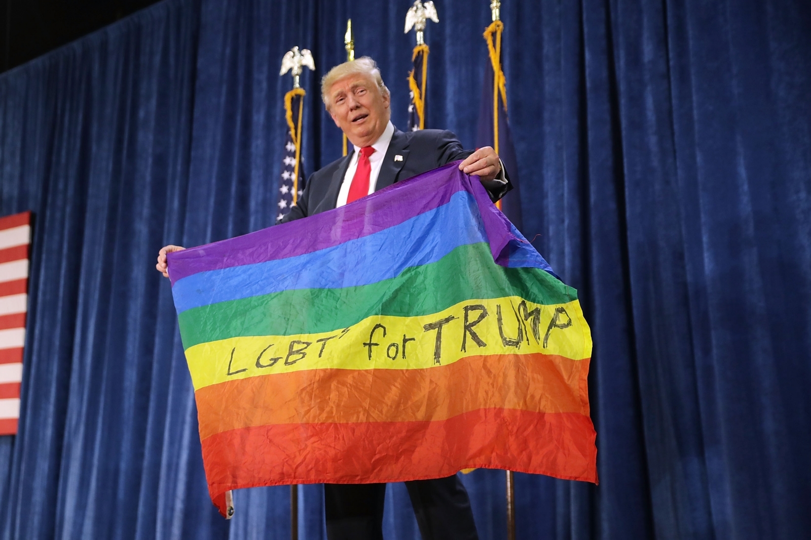 trump holding a gay pride flag trump holding a gay pride flag