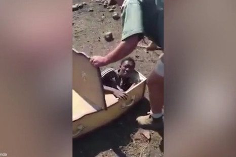 Disturbing video shows two white farmers forcing a black man into a coffin