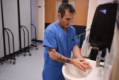 Hospital worker washes hands