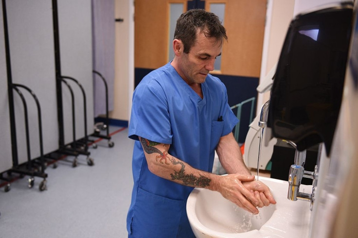 Hospital worker washes hands