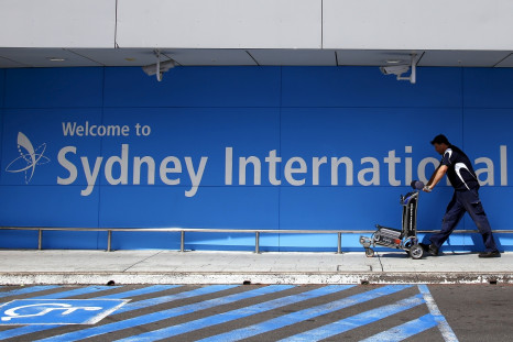 A passenger pushes a trolley as he walks towards the departures area at Sydney International Airport, Australia, 