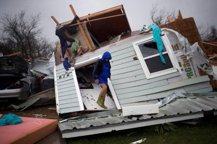 Woman stands on her front door as she surveys her property devastated by Hurricane Harvey in Rockport, Texas