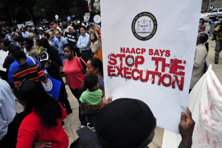 Protesters show their support for death row inmate Troy Davis during a rally at the capitol in Atlanta; over 1000 people attended his funeral today.